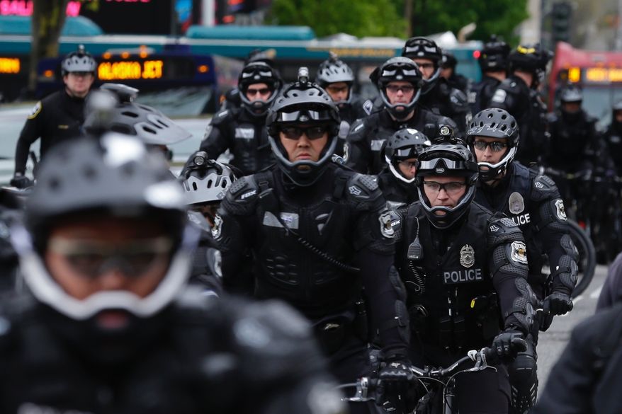 Seattle Police Officers stage near a May Day protest, Monday, May 1, 2017, in Seattle.  Immigrant and union groups marched in cities across the United States on Monday, to mark May Day and protest against President Donald Trump&#39;s efforts to boost deportations. The day has become a rallying point for immigrants in the U.S. since demonstrations were held in 2006 against a proposed immigration enforcement bill. (AP Photo/Ted S. Warren)