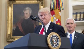 A portrait of former President Andrew Jackson hangs on the wall behind President Donald Trump, accompanied by Vice President Mike Pence, in the Oval Office at the White House in Washington on March 31, 2017. (Associated Press) **FILE**