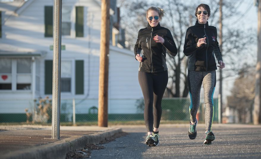 In a Feb. 6, 2017 photo, Cheryl DeLorenzo of Paulsboro, right, and her daughter Leann DeLorenzo, who resides in Philadelphia, go for a training run in Paulsboro, N.J. The mother and daughter started running together years ago, when Leann was playing on her high school boys' soccer team and wanted her runner-mom to help her train. A few years ago, the two started running marathons together, and now they're training to enter their first triathlon. (Chris LaChall/Camden Courier-Post via AP)