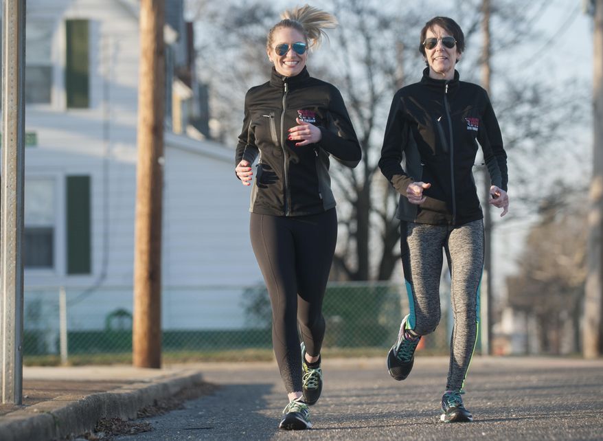 In a Feb. 6, 2017 photo, Cheryl DeLorenzo of Paulsboro, right, and her daughter Leann DeLorenzo, who resides in Philadelphia, go for a training run in Paulsboro, N.J. The mother and daughter started running together years ago, when Leann was playing on her high school boys' soccer team and wanted her runner-mom to help her train. A few years ago, the two started running marathons together, and now they're training to enter their first triathlon. (Chris LaChall/Camden Courier-Post via AP)