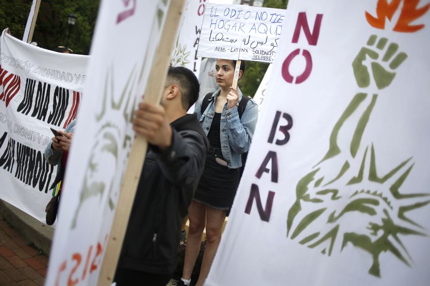 A group of people, including Sophia Albanaa, an international student from Kuwait, participate in a May Day rally in New Brunswick, N.J., Monday, May 1, 2017. The demonstrations on May Day, celebrated as International Workers' Day, follow similar actions worldwide in which protesters from the Philippines to Paris demanded better working conditions. In the United States, there were no reports of violence, but protesters vowed to participate in civil disruptions throughout the day to draw attention to the importance of immigrants in American communities. (AP Photo/Seth Wenig)