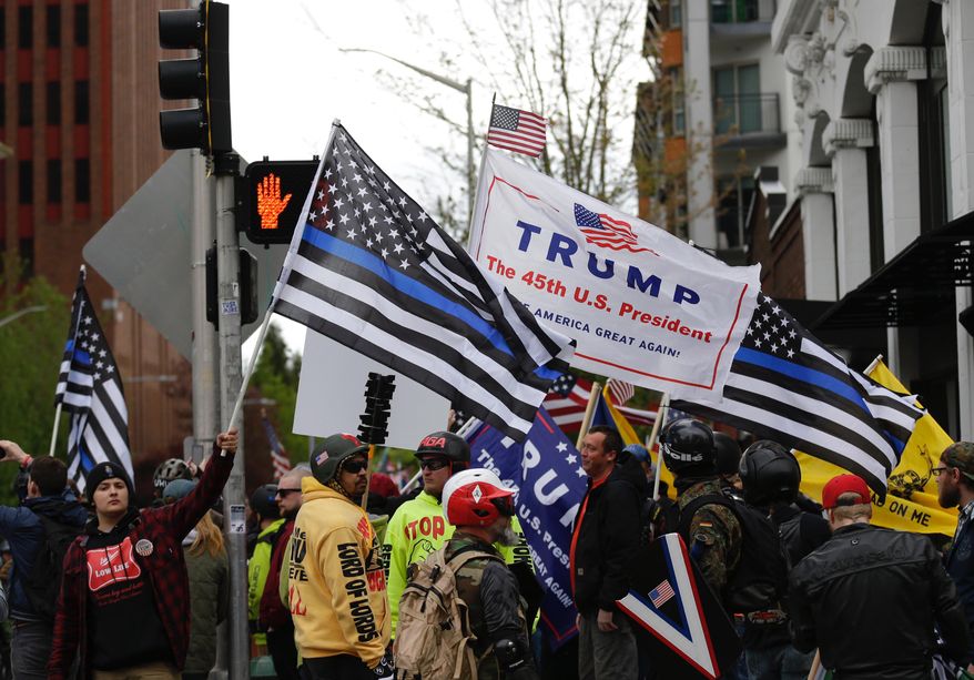 Supporters of President Donald Trump take part in a May Day protest, Monday, May 1, 2017, in Seattle. Immigrant and union groups marched in cities across the United States on Monday, to mark May Day and protest against President Donald Trump's efforts to boost deportations. The day has become a rallying point for immigrants in the U.S. since demonstrations were held in 2006 against a proposed immigration enforcement bill. (AP Photo/Ted S. Warren)