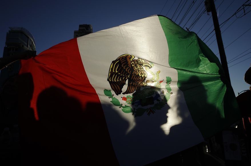 People celebrate during a May Day march Monday, May 1, 2017, in Las Vegas. Union members and activists marched along and near the Las Vegas Strip to highlight immigration issues and push back against Trump administration policies. (AP Photo/John Locher)