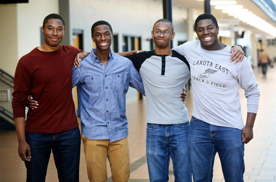FILE - In a Wednesday, April 5, 2017 file photo, Lakota East seniors and quadruplet brothers from left, Zachary, Aaron, Nigel, and Nick Wade pose together at Lakota East High School, in Liberty Township, Ohio. brothers in Ohio have decided to attend Yale University together, after all were accepted at some of the nation's top universities including each at both Yale and Harvard. They revealed their choices via video chat Monday, May 1, 2017, morning on NBC “Today” Show. (Greg Lynch /The Journal-News via AP, File)