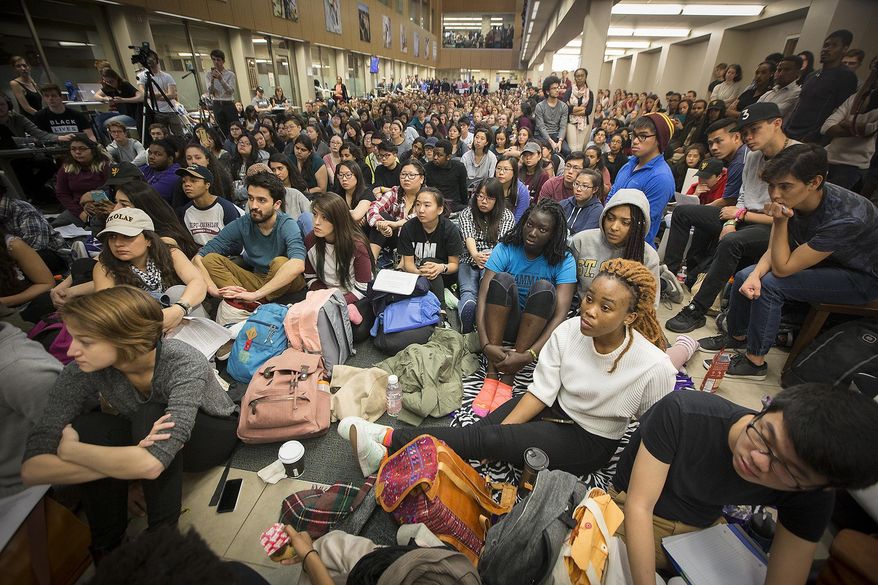 St. Olaf College students fill Tomson Hall to boycott classes and demand action and dialogue after numerous acts of incidents of racial hate on campus, Monday, May 1, 2017 in Northfield, Minn. Hundreds of students boycotted classes at St. Olaf College on Monday, instead packing an administration building to protest a rash of racist and threatening messages left around campus. (Elizabeth Flores/Star Tribune via AP)