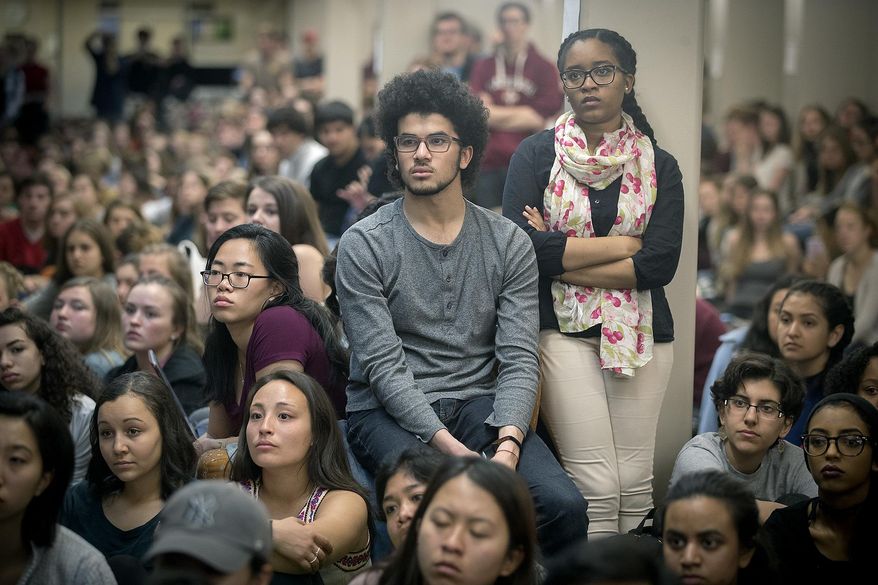 St. Olaf College students fill Tomson Hall to boycott classes and demand action and dialogue after numerous acts of incidents of racial hate on campus, Monday, May 1, 2017 in Northfield, Minn. Hundreds of students boycotted classes at St. Olaf College on Monday, instead packing an administration building to protest a rash of racist and threatening messages left around campus. (Elizabeth Flores/Star Tribune via AP)
