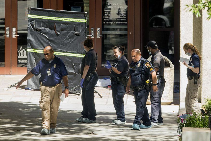 Officials investigate after a fatal stabbing attack at the University of Texas campus, Monday, May 1, 2017, in Austin, Texas. (Jay Janner/Austin American-Statesman via AP)
