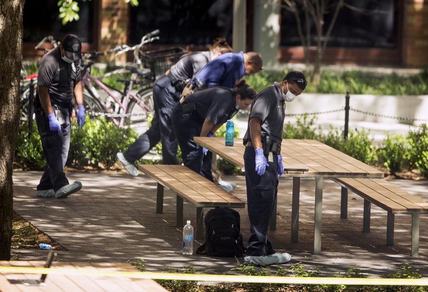 Officials investigate after a fatal stabbing attack at the University of Texas campus, Monday, May 1, 2017, in Austin, Texas. (Jay Janner/Austin American-Statesman via AP)