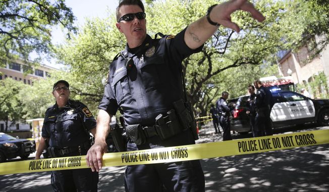 Law enforcement officers secure the scene after a fatal stabbing attack on the University of Texas campus Monday, May, 1, 2017. (Tamir Kalifa/Austin American-Statesman via AP)