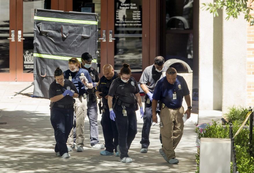 Officials investigate after a fatal stabbing attack at the University of Texas campus, Monday, May 1, 2017, in Austin, Texas. (Jay Janner/Austin American-Statesman via AP)