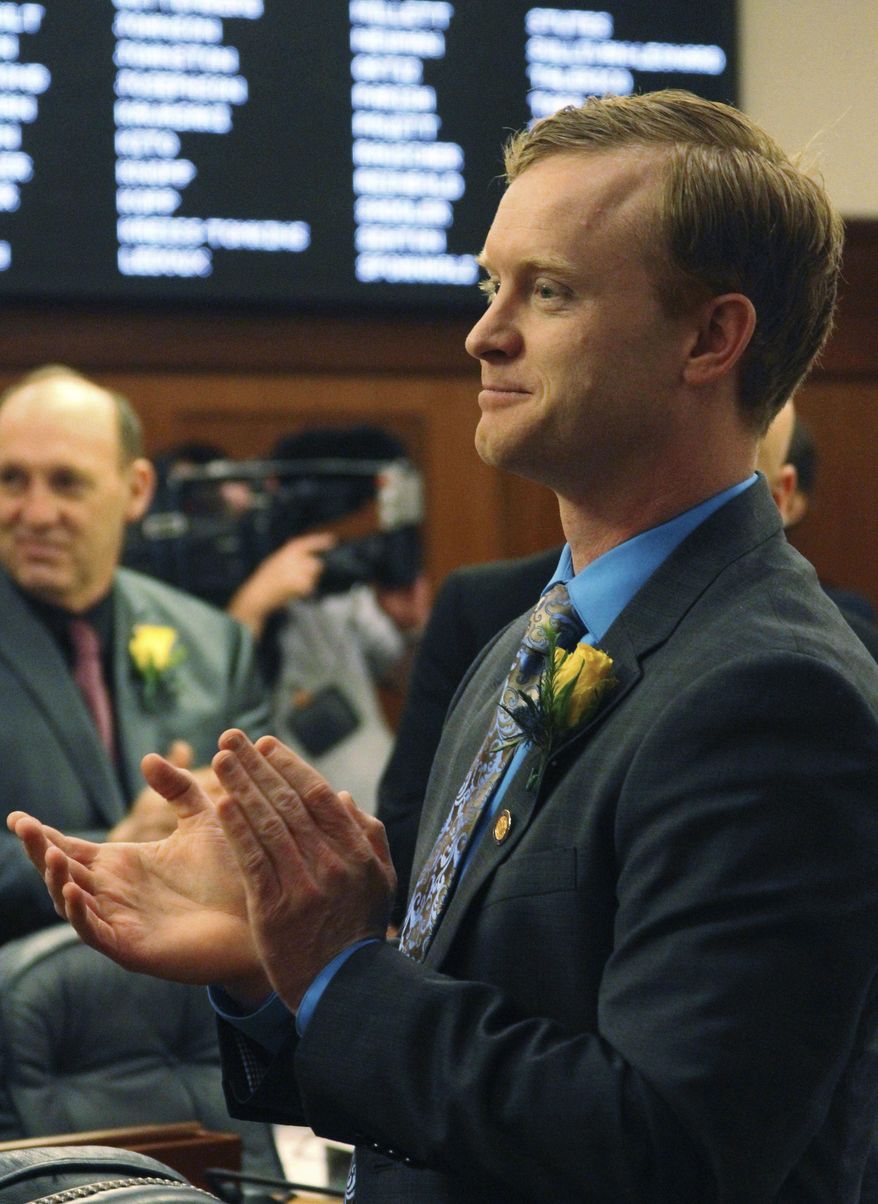 In this Jan. 17, 2017, photo Alaska state Rep. David Eastman applauds in the House chamber in Juneau, Alaska. Eastman, a conservative lawmaker, has successfully tacked an anti-abortion message onto an otherwise innocuous resolution in the Alaska House aimed at raising awareness about sexual assault and child abuse, calling abortion "the ultimate form of child abuse." The measure's fate is unclear; bills typically only go to the full body if they have enough votes to pass. (AP Photo/Mark Thiessen)