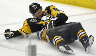 Pittsburgh Penguins&#39; Sidney Crosby (87) lies on the ice after taking a hit from Washington Capitals&#39; Matt Niskanen during the first period of Game 3 in an NHL Stanley Cup Eastern Conference semifinal hockey game against the Washington Capitals in Pittsburgh, Monday, May 1, 2017. One hit may have changed the tenor of the NHL playoffs. Penguins star Sidney Crosby&#39;s status going forward is uncertain. (AP Photo/Gene J. Puskar)