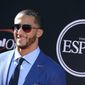 FILE - In this July 16, 2014, file photo, San Francisco 49ers&#39; Colin Kaepernick arrives at the ESPY Awards at the Nokia Theatre in Los Angeles. Video and pictures from social media posted on May 1, 2017, show Kaepernick standing outside a New York City parole office with two boxes of custom-made suits. An Instagram post by Kaepernick’s “Know Your Rights Camp” campaign says the suits will make parolees “better equipped to achieve gainful employment” and “live more productive lives.” (Photo by Jordan Strauss/Invision/AP, File )