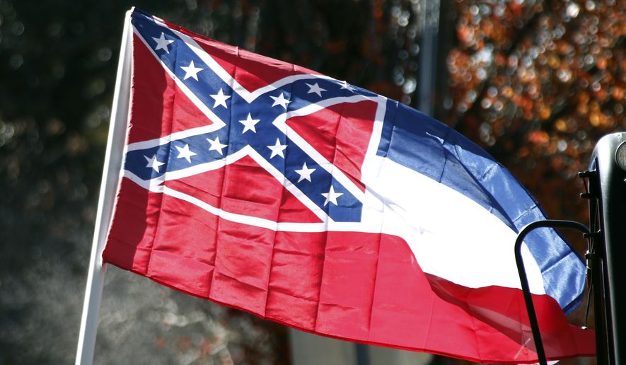 FILE - In this Tuesday, Jan. 19, 2016 file photo, a state flag of Mississippi is unfurled by Sons of Confederate Veterans and other groups on the grounds of the state Capitol in Jackson, Miss., in support of keeping the Confederate battle emblem on the state flag. Some black Mississippi officials say they are boycotting a regional legislative meeting that their own state is hosting, which meets July 29-Aug. 2, 2017, in Biloxi, to protest the Confederate battle emblem on the state flag. (AP Photo/Rogelio V. Solis, File)