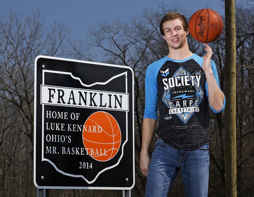 In this 2015 file photo, then-Franklin High School senior Luke Kennard poses next to one of the signs that were installed in Franklin , Ohio, honoring his 2014 Ohio' Mr. Basketball honor. In the past few weeks, two of the signs have been stolen forcing the city to take down the others. (Nick Graham/The Journal-News via AP)