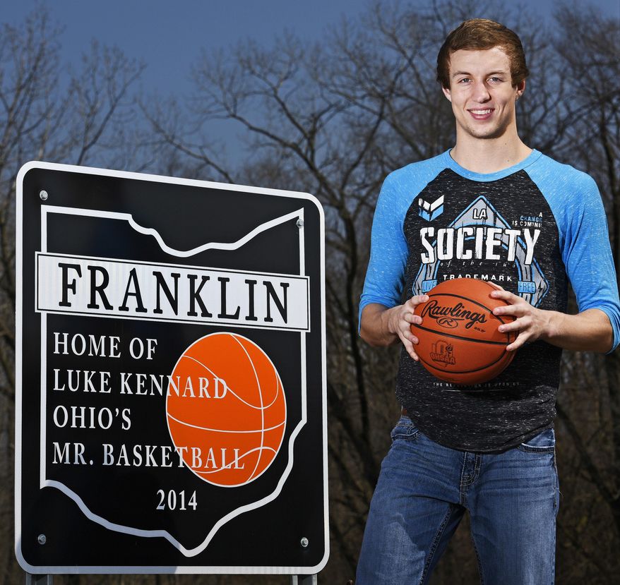 In this 2015 file photo, then-Franklin High School senior Luke Kennard poses next to one of the signs that were installed in Franklin , Ohio, honoring his 2014 Ohio' Mr. Basketball honor. In the past few weeks, two of the signs have been stolen forcing the city to take down the others. (Nick Graham/The Journal-News via AP)