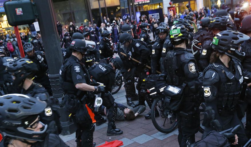 Seattle Police officers surround a man as they make an arrest, Monday, May 1, 2017, during a May Day protest in Seattle. (AP Photo/Ted S. Warren)