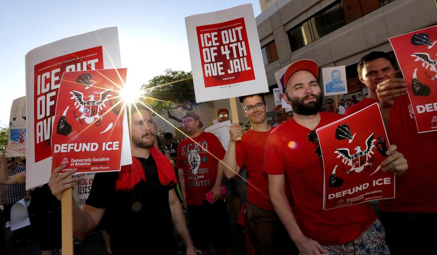 Protesters march through downtown Phoenix, Monday, May 1, 2017. Immigrant and union groups marched in cities across the United States on Monday to mark May Day and protest against President Donald Trump's efforts to boost deportations. (AP Photo/Matt York)
