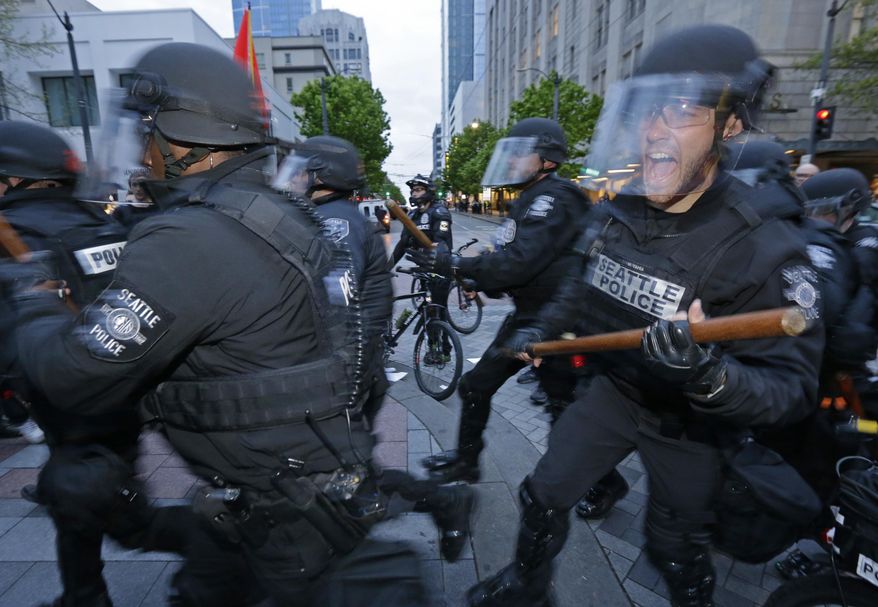 Seattle Police officers move in to make an arrest, Monday, May 1, 2017, during a May Day protest in Seattle. (AP Photo/Ted S. Warren)