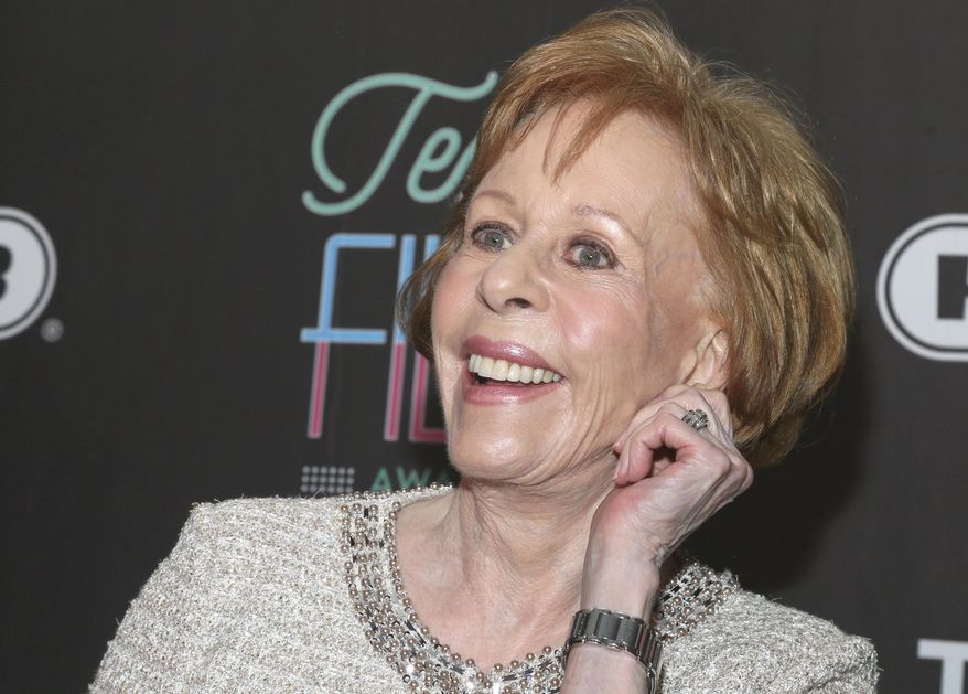 FILE - In this March 10, 2016 file photo, Texas Film Hall of Fame honoree Carol Burnett tugs on her ear at the 2016 Texas Film Awards at Austin Studios in Austin, Texas. The 84-year-old comedy legend could return to a full-time work schedule if the pilot she recently shot for ABC, "Household Name,” produced by Amy Poehler, becomes a regular series. (Photo by Jack Plunkett/Invision/AP, File)