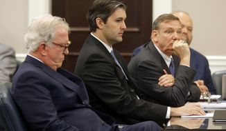 FILE - In this Monday, Dec. 5, 2016, file photo, Defense attorneys Andy Savage, left, Don McCune, and Miller Shealy, right, sit around former North Charleston police officer Michael Slager at theCharleston County court in Charleston, S.C. Slager is pleading guilty to violating the civil rights of an unarmed black motorist he shot and killed during a 2015 traffic stop. A copy of the plea agreement obtained by The Associated Press Tuesday, May 2, 2017, also shows state prosecutors are dropping a pending murder charge in the death of Walter Scott. (Grace Beahm/The Post And Courier via AP, Pool, File)