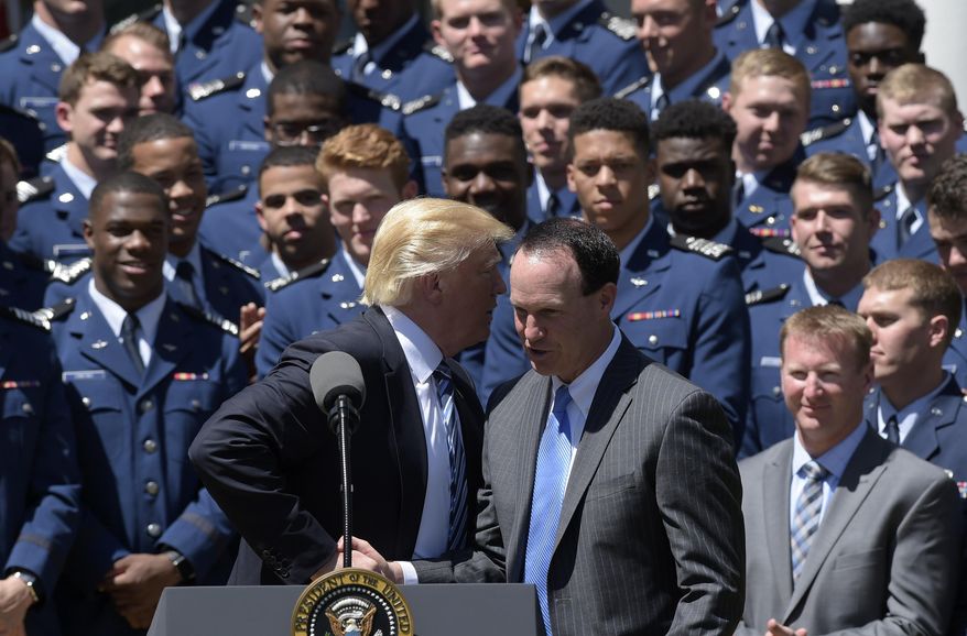 President Donald Trump talks with U.S. Air Force Academy football team coach Troy Calhoun in the Rose Garden of the White House in Washington, Tuesday, May 2, 2017, during a presentation ceremony of the Commander-in-Chief trophy to the Air Force Academy football. (AP Photo/Susan Walsh)