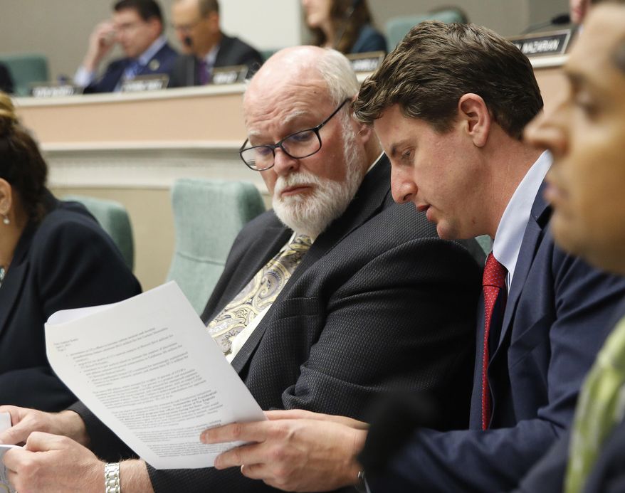 State Sen. Jim Beal, D-San Jose, left, and Henry Stern, D-Canoga Park, look over documents concerning a state audit of the UC Presidents office, during a hearing of the Joint Legislative Audit Committee, Tuesday, May 2, 2017,in Sacramento, Calif. Lawmakers where looking into the audit, conducted by the office of State Auditor Elaine Howle, that found that UC administrators hid $175 million from the public while the university system raised tuition and asked lawmakers for more money. Napolitano has disputed the audit's findings.(AP Photo/Rich Pedroncelli)
