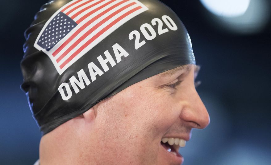 Nebraska Gov. Pete Ricketts wears a swim cap on Monday, May 1, 2017, in Omaha, Neb., following the announcement that the U.S. Olympic swim trials will be held in Omaha in 2020. It will be the fourth straight time Nebraska's largest city will host the event. (Rebecca Gratz/Omaha World-Herald via AP)