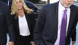 Singer Alanis Morissette, left, arrives with attorney Allen Grodsky at U.S. federal court for the sentencing in the embezzlement case of her former manager Jonathan Todd Schwartz, Wednesday, May 3, 2017, in Los Angeles. Schwartz pleaded guilty earlier this year after admitting he embezzled more than $7 million from the singer and other celebrities. (AP Photo/Chris Pizzello)