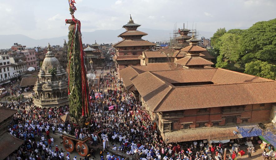 In this May 2, 2017, photo, Nepalese members of the Newar community pull the Rato Machindranath Chariot in Lalitpur, Nepal. The legend says that around the 7th century there was massive drought in the Kathmandu valley. It was believed that the arrival of the red deity would end the drought and bring back the rainfall. Hence then King Narendra Dev along with a priest and farmer travelled to what is now the Assam state in India and brought back Karunamaya, the god of compassion. It is popularly now known as Rato Machindranath. (AP Photo/Niranjan Shrestha)