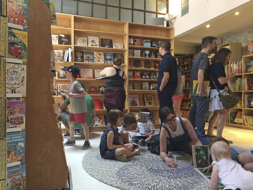 This April 29, 2017 photo shows the children's area of the new Books Are Magic bookstore in Brooklyn, New York, on the day it opened. The store is owned by novelist Emma Straub and her husband, who decided to open the store after another beloved neighborhood bookstore closed. Straub is one of a number of authors who own bookstores around the country, including Ann Patchett and Jeff Kinney. (AP Photo/Beth J. Harpaz)