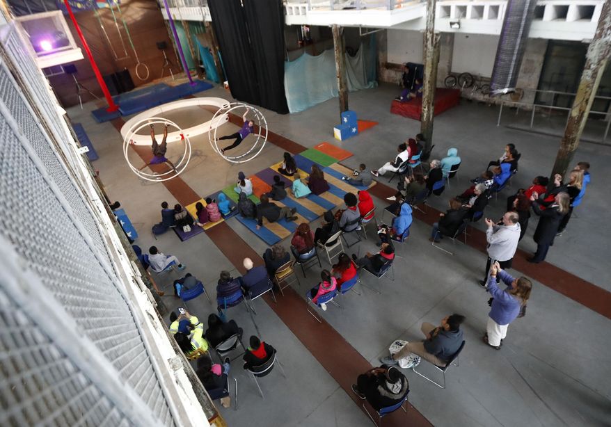 In a photo taken Thursday, March 30, 2017, people watch a performance by the Trenton Circus Squad in Trenton, N.J. The squad, comprised of kids age 12 to 17 from both the struggling city of Trenton and its wealthier suburbs together, using circus skills to give kids a sense of belonging and a belief in their own abilities. Tom von Oehsen and Zoe Brookes created the group two years ago to try to change perceptions and stereotypes that lead to negative assumptions about teens in inner cities. (AP Photo/Julio Cortez)