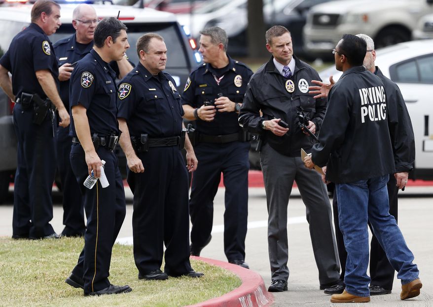 Officers work at a fatal shooting scene on the North Lake College campus in Irving, Texas, Wednesday, May 3, 2017. The situation prompted a lockdown at the school in the Dallas suburb. (Jae S. Lee/The Dallas Morning News via AP)