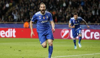 Juventus&#39; Gonzalo Higuain celebrates after scoring during the Champions League semifinal first leg soccer match between Monaco and Juventus at the Louis II stadium in Monaco, Wednesday, May 3, 2017. (AP Photo/Claude Paris)