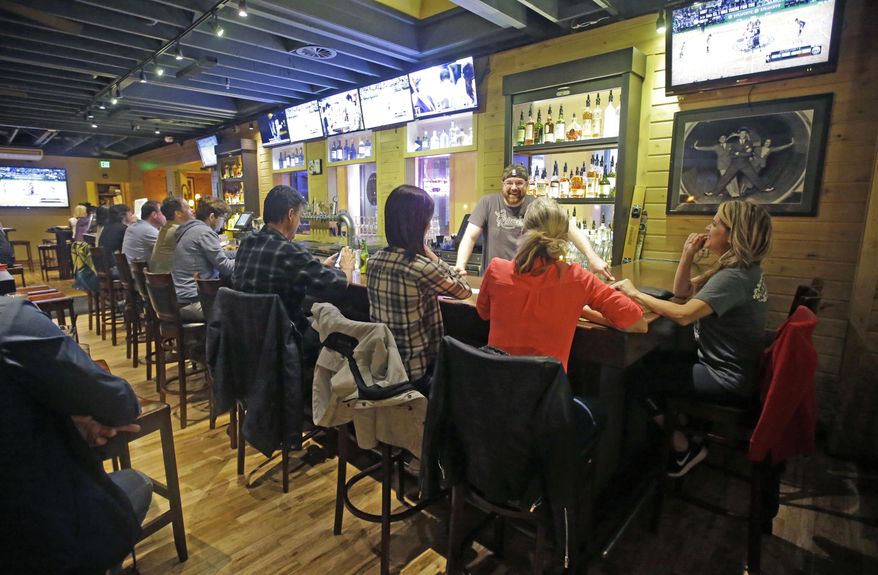 People sit at the bar at Gracie's Bar and Restaurant, in Salt Lake City Tuesday, May 2, 2017. Salt Lake City leaders and tourism officials playfully jabbed back at Golden State Warriors players who bemoaned the lack of nightlife in Utah, hoping to combat the predominantly Mormon state's reputation as a boring place where it's tough to get a drink. The tourism agency in the state capital launched a new website and video Monday titled, "There's nothing to do in Salt Lake" that features people enjoying drinks and food at popular breweries, bars, restaurants and sporting venues. (AP Photo/Rick Bowmer)