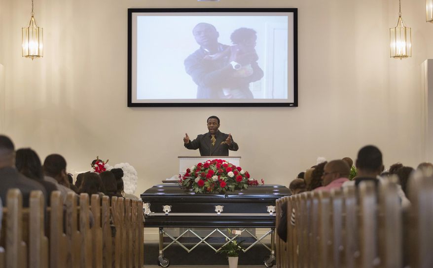 FILE - In this May 2, 2015 file photo, Earl Lewis, Jr. speaks during the funeral service for William Chapman II in Portsmouth, Va. Former Portsmouth police officer Steven Rankin was sentenced in October 2016 to 2½ years in prison for fatally shooting the unarmed 18-year-old while responding to a shoplifting call outside a Wal-Mart on April 22, 2015. Prosecutors allege Rankin killed Chapman "willfully, deliberately and with premeditation." Chapman's body was reportedly delivered to the medical examiner with handcuffs still bound behind his back. Some witnesses said Chapman was combative, and one said he knocked away Rankin's stun gun. Rankin, who is white, was fired. (L. Todd Spencer/The Virginian-Pilot via AP)