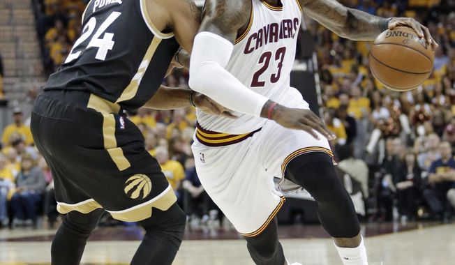 Cleveland Cavaliers&#x27; LeBron James (23) drives against Toronto Raptors&#x27; Norman Powell (24) during the first half in Game 2 of a second-round NBA basketball playoff series, Wednesday, May 3, 2017, in Cleveland. (AP Photo/Tony Dejak)