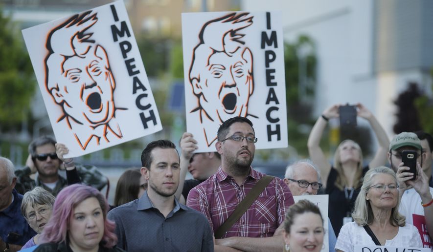 People look on during a health care rally Thursday, May 4, 2017, in Salt Lake City. Utah&#39;s all-Republican House delegation voted Thursday in favor of a health care overhaul that could impact people with pre-existing conditions, triggering serious worries from people who fit that category. (AP Photo/Rick Bowmer)