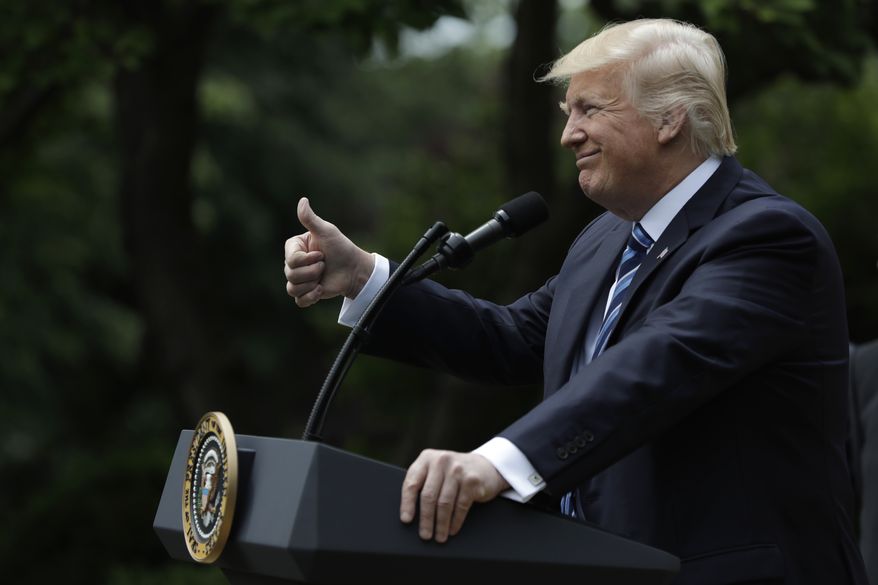 President Donald Trump gives a thumbs-up in the Rose Garden of the White House in Washington, Thursday, May 4, 2017, before signing an executive order aimed at easing an IRS rule limiting political activity for churches. (AP Photo/Evan Vucci) ** FILE **