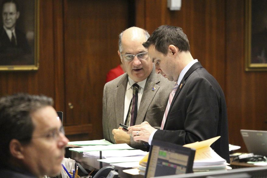 Arizona House Majority Leader John Allen, standing left, in seen in the floor of the Arizona house in Phoenix, Ariz., Thursday, May 4, 2017. Allen said Thursday he has secured enough Republican votes in his chamber to pass a $9.8 billion state budget package and he believes a massive university loan plan also has enough GOP votes to pass. The Arizona Legislature was moving closer to passing a state budget plan late Thursday afternoon, with deal-cutting securing support from defiant Republicans in an effort to gain passage without minority Democratic support. (AP Photo/ Bob Christie)