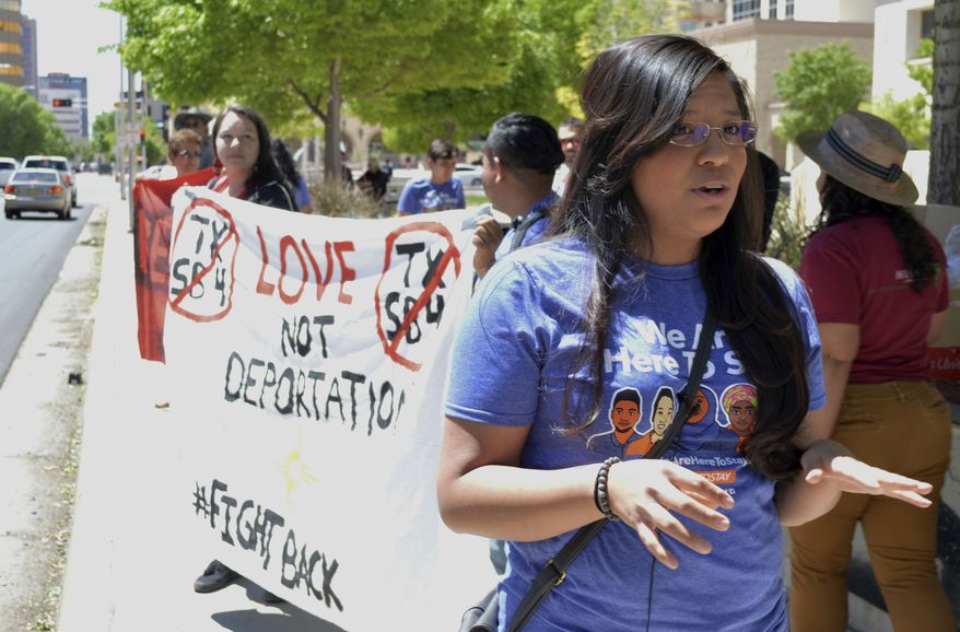 In this May 1, 2017 photo, Yazmin Irazoqui Ruiz, 25, of Albuquerque, N.M., speaks at an immigration rally in Albuquerque and about her mixed feelings regarding Cinco de Mayo. President Donald Trump's immigration policies and rhetoric are leaving some Mexican Americans and immigrants feeling at odds with a day they already thought was appropriated by beer and liquor companies, event promoters and local bars. (AP Photo/Russell Contreras)