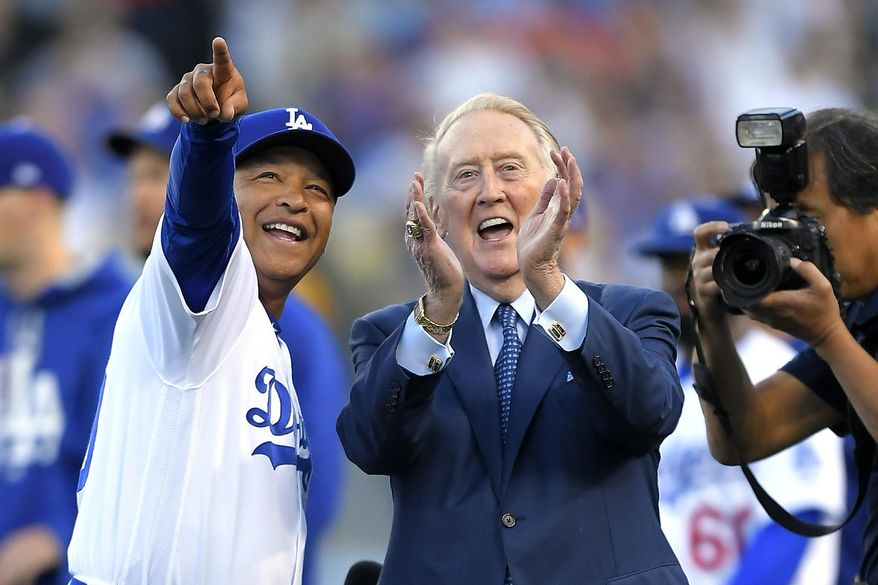 Broadcaster Vin Scully stands with Los Angeles Dodgers manager Dave Roberts during Scully's induction into the Los Angeles Dodgers Ring of Honor, prior to a baseball game between the Dodgers and the San Francisco Giants, Wednesday, May 3, 2017, in Los Angeles. (AP Photo/Mark J. Terrill)