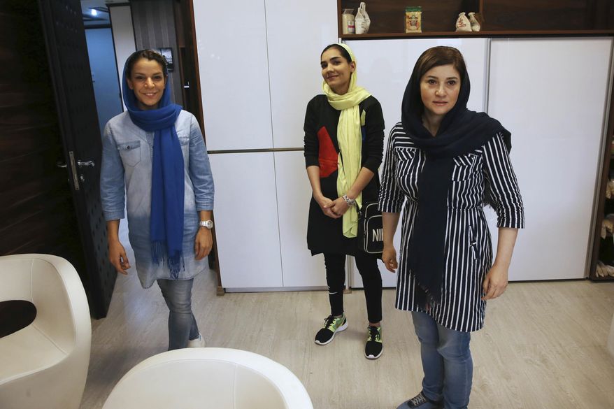 Iranian national basketball team players Ayrin Artoonian, left, Shadi Abdolvand, center, and head of Koosha Sanat club Nasim Daneshpajooh attend an interview with The Associated Press in Tehran, Iran, Thursday, May 4, 2017. Basketball enthusiasts around the world said a decision to allow players to wear religious headgear in competition will encourage more people to play the sport because it gives participants the right to practice their faith and focus on playing ball. Abdolvand said basketball will change in Iran because younger players will be encouraged to &amp;quot;pursue their goals.&amp;quot; (AP Photo/Vahid Salemi)