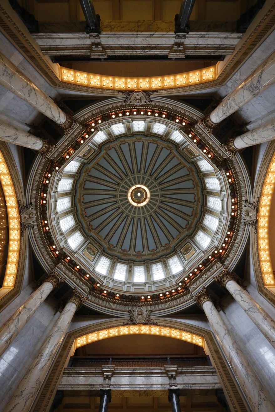 The Beaux Arts style of architecture of the Mississippi Capitol, highlighted by the use of various types of glass throughout and the use of 750 light fixtures, surrounding the rotunda, are factors that helped earn the designation of a national historic landmark, Thursday, May 4, 2017, in Jackson, Miss. An official from the National Park Service made the presentation in the rotunda of the building that opened in 1903. (AP Photo/Rogelio V. Solis)