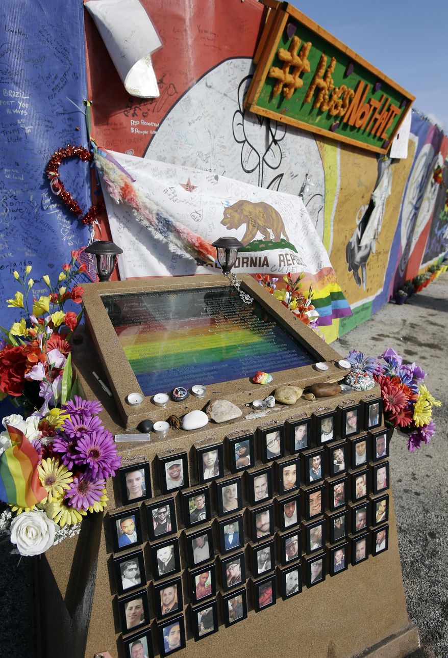 A small memorial with the names and photos of the victims of the Pulse nightclub shooting sits in front of the site, Thursday, May 4, 2017, in Orlando, Fla. Pulse nightclub owner Barbara Poma said the site will become a memorial and a museum to honor the 49 people who were killed and the dozens more who were injured during the worst mass shooting in modern U.S. history. (AP Photo/John Raoux)