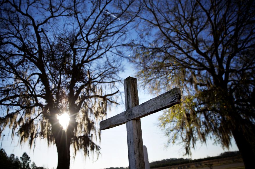 ADVANCE FOR USE MONDAY, MAY 8, 2017 AND THEREAFTER-In this Wednesday, Feb. 1, 2017 photo, a cross stands outside a church in Estill, S.C. Estill Middle School stands out as having one of the nation's largest single sexual assault cases reported on school grounds - at least four students, ages 11 to 14, were victimized by as many as 30 kids in 2013. (AP Photo/David Goldman)