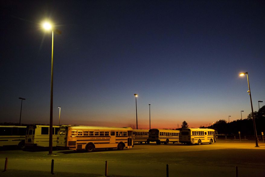 ADVANCE FOR USE MONDAY, MAY 8, 2017 AND THEREAFTER-This Tuesday, Jan. 31, 2017 photo shows school buses parked at Estill Middle School, where a sexual assault case was reported in 2013, in Estill, S.C. Most parents have no choice but to send their children to the public schools. More than 90 percent of students at Estill Middle School receive free or reduced lunch. (AP Photo/David Goldman)