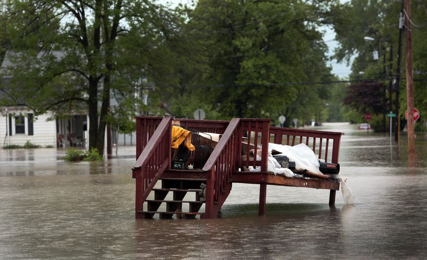 A deck floated from a mobile home landed in the middle of Second Street in downtown Pacific, Mo., Wednesday, May 3, 2017. Heavy rains have swollen many rivers to record levels in parts of Missouri, Illinois, Oklahoma and Arkansas. (Robert Cohen/St. Louis Post-Dispatch via AP)