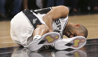 In this Wednesday, May 3, 2017 photo, San Antonio Spurs&#39; Tony Parker holds his left leg after getting injured in the second half of Game 2 of the Western Conference semifinals at the AT&amp;amp;T Center against the Houston Rockets in San Antonio. The Spurs announced on Thursday, May 4, 2017,  that Parker has a ruptured quadriceps tendon in his left leg. (Jerry Lara/The San Antonio Express-News via AP)