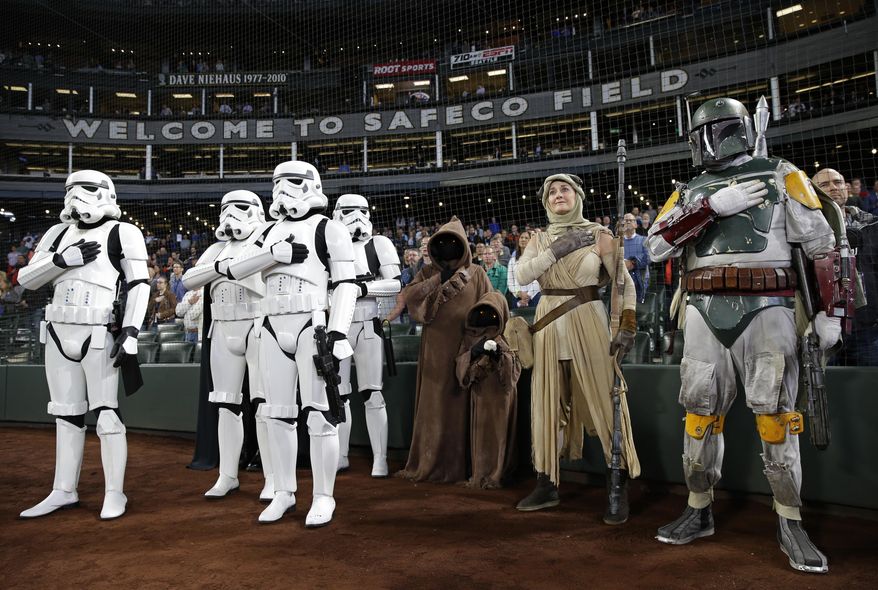 People dressed as Star Wars characters stand during the national anthem at Safeco Field before a baseball game between the Seattle Mariners and the Los Angeles Angels, Thursday, May 4, 2017, in Seattle. The appearance was part of a Star Wars Day promotion. (AP Photo/Ted S. Warren)